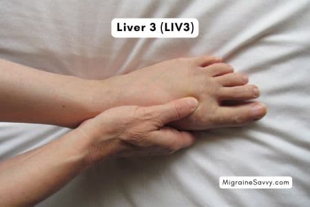 Liver Meridian Point 3 hand position for migraine relief.