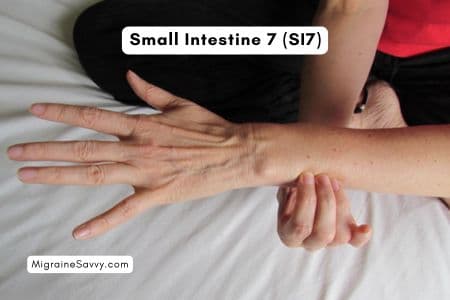 Hand position for SI7- Small Intestine 7 pressure point on outer wrist for releasing neck tension.